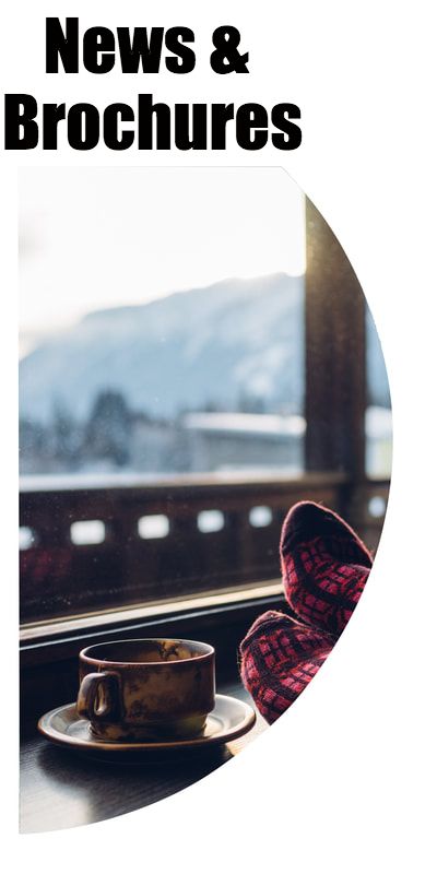 Feet and coffee mug overlooking winter landscape
